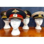 Four Worldwide police hats comprising an Indonesian National police cap (POLRI), a Danish police