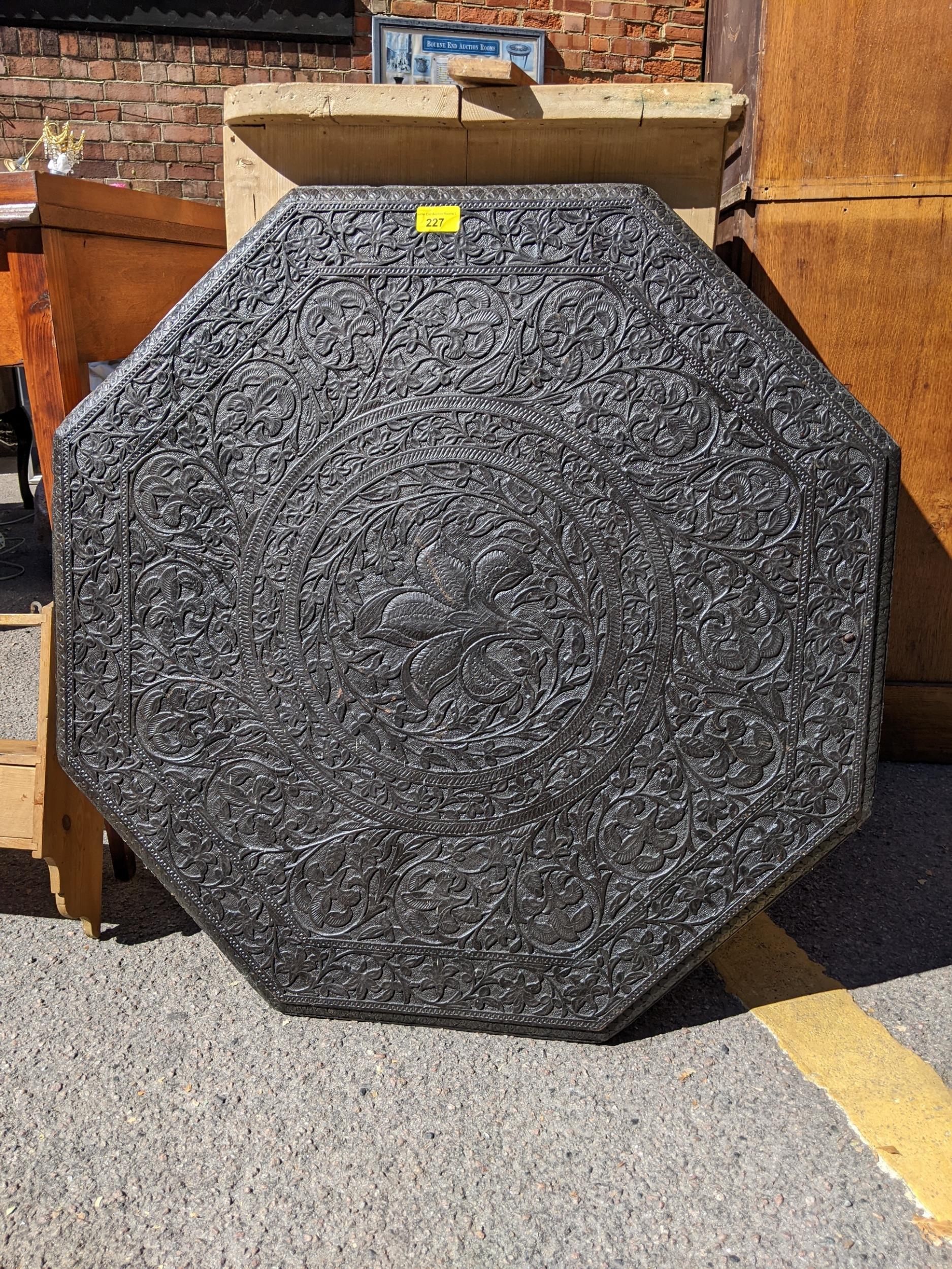 A late 19th/early 20th century Indian carved table top with a pine spice rack Location: - Image 2 of 3