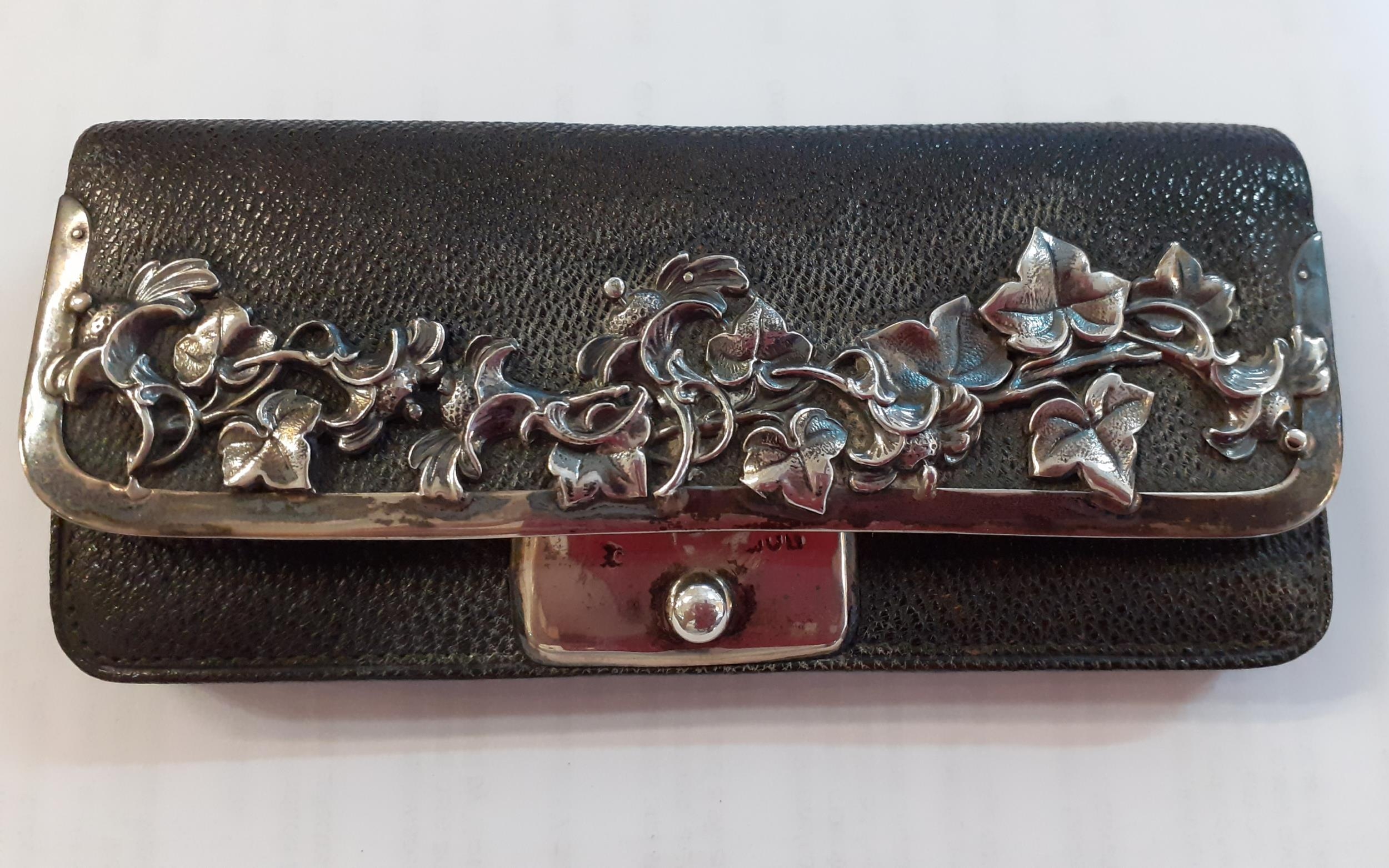 A Victorian black leather purse with silver vine decoration and silver clasp. Location:RAB