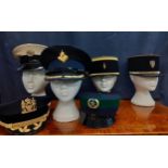 Six Worldwide police caps comprising an RAF police cap made by A.Grantham, size 55, 2 French