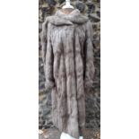 A vintage grey fur coat, possibly chinchilla, together with mixed fur stoles and a muff. Location: