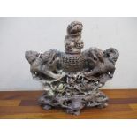 A 20th century Chinese carved soapstone mantel ornament depicting lion dogs amongst rockwork and