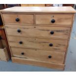 A pine chest of 2 short and 3 long drawers having black bun handles