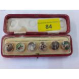 A set of 6 early 20th Century gold plated and enamelled shirt studs with images of wine, horse