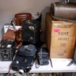 A vintage Kodascope Eight model 30 in original wooden box, together with vintage cameras and a