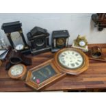 The component parts of clocks to include two slate cased examples, an ebonized Portico clock case