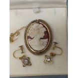 A 9ct gold framed cameo brooch and a pair of 9ct gold earrings 8.95g Location: