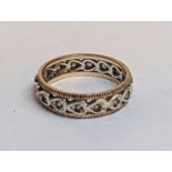 A late 19th/early 20th century yellow and white metal eternity ring inset with white stones, 3g