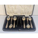 A set of six silver teaspoons and matching sugar tongs, cased Location: