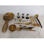 A selection of miniature silver items to include a hand mirror, trophies, and a pin cushion,