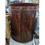 A Georgian mahogany bow fronted two door wall hanging cabinet Location: