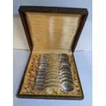A set of twelve early 20th century silver coffee spoons in a fitted case, 99.6g Location: