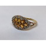 A 9ct gold ring inset with diamonds and yellow stones, 3g Location:
