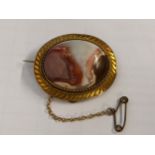 A gold coloured brooch set with an agate cabochon, 9.6g Location:
