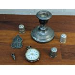 Silver and collectables to include a fob watch, a dwarf candlestick, three thimbles, and an ARP