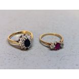 A 9ct gold ring having central sapphires with paste stones and a silver gilt example with central