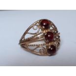 A 9ct gold and 3 red stone cabochon ring in the Eastern style with filigree design, total weight 2.
