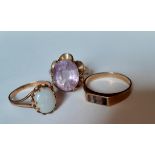 A 9ct gold ring with amethyst coloured cabochon in a contemporary floral mount, total weight 3.21g