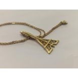 An 18ct gold pendant in the form of Concorde, stamped 750, on a yellow metal chain, total weight 6.