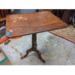 An early 19th century mahogany snap top table having turned column and three splayed legs Location: