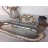 A small group of silver items to include a trinket tray, an ashtray and a white metal jug, total