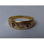 An 18ct gold ring set with a diamond and two rubies Location: