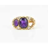 A 9ct yellow gold, amethyst and diamond gypsy style dress ring, set with two (third one missing)