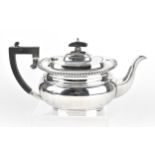 A George V silver tea pot by Barker Brothers Silver Ltd, Birmingham 1934, designed with gadrooned