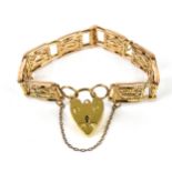 A 9ct yellow and rose gold fancy gate bracelet, with heart padlock clasp and safety chain, weight 26