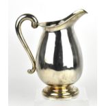 A modern Scottish silver water jug, Edinburgh 2004, of bulbous form with scroll handle, on a stepped