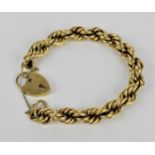 A 9ct yellow gold rope twist chain bracelet, with heart locket clasp and safety chain, weight 29.5