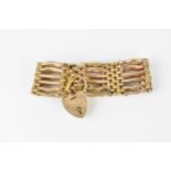 A 9ct yellow gold gate link bracelet, with textured brick links, heart shaped clasp and safety