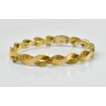 A Victorian 15ct yellow gold bracelet, with cross over articulated links with three central floral