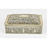 A British silver cigarette box with domed lid decorated with repousse scrolling leaves and