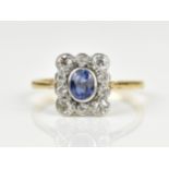 An 18ct yellow gold, platinum, sapphire and diamond cluster ring, set with single oval cut