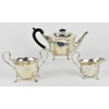 An Edwardian silver three piece tea set by Joseph Gloster, Birmingham 1904, comprising a teapot,