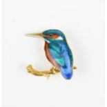 A 9ct yellow gold enamelled kingfisher brooch, modelled on a naturalistic textured gold branch, with