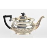 An Edwardian silver teapot by George Nathan & Ridley Hayes, Chester 1908, with part fluted body,