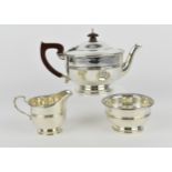 A George VI silver three piece tea set by Adie Brothers Ltd, Birmingham 1946, comprising a teapot, a