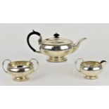 A George V silver three piece tea set by Walker & Hall, Sheffield 1926, comprising a teapot, twin-