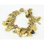 A 9ct yellow gold curb link charm bracelet, with over twenty charms with various animals and
