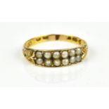 A Victorian 22ct yellow gold and pearl ring, with a twin row of twelve pearls flanked with small