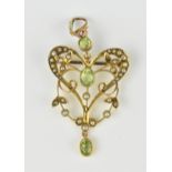 An Edwardian 9ct yellow gold, peridot and pearl pendant/brooch, in the shape of a heart with central