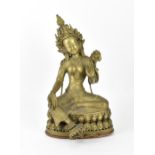 A Sino-Tibetan bronze figure of the Buddha Green Tara, her left hand holding a lotus flower, while