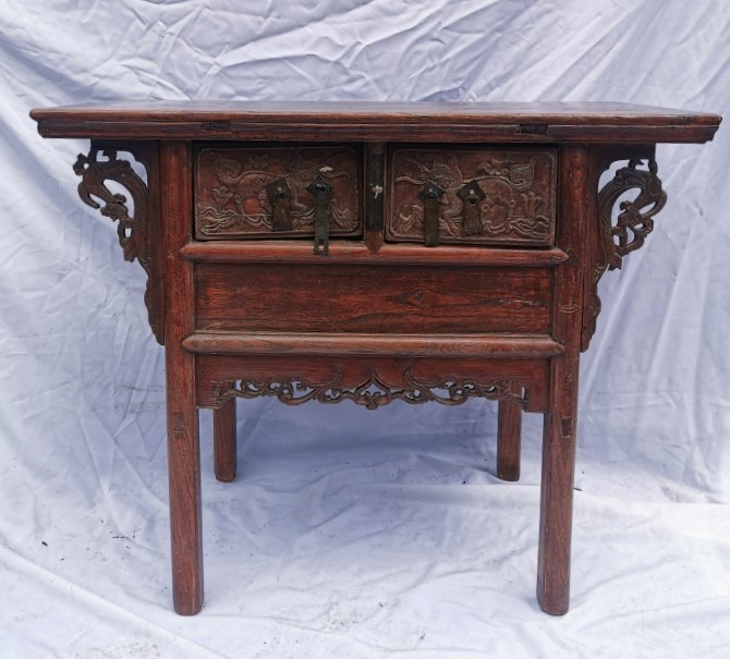 A Chinese late Qing dynasty hardwood altar table, the rectangular top above two central drawers with
