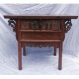 A Chinese late Qing dynasty hardwood altar table, the rectangular top above two central drawers with