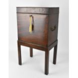 A George III mahogany wine cellarette, of square form with six bottle compartmentalised interior,