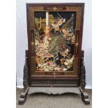 A large Chinese hardstone, lacquer and hardwood screen, with central mythological battle scene,