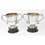 A pair of George V silver tennis trophy cups by Atkin Brothers, Sheffield 1926, each twin-handled on