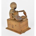 A Japanese Meiji period wooden Kobe automaton toy, modelled as a figure holding a dish and a bottle,
